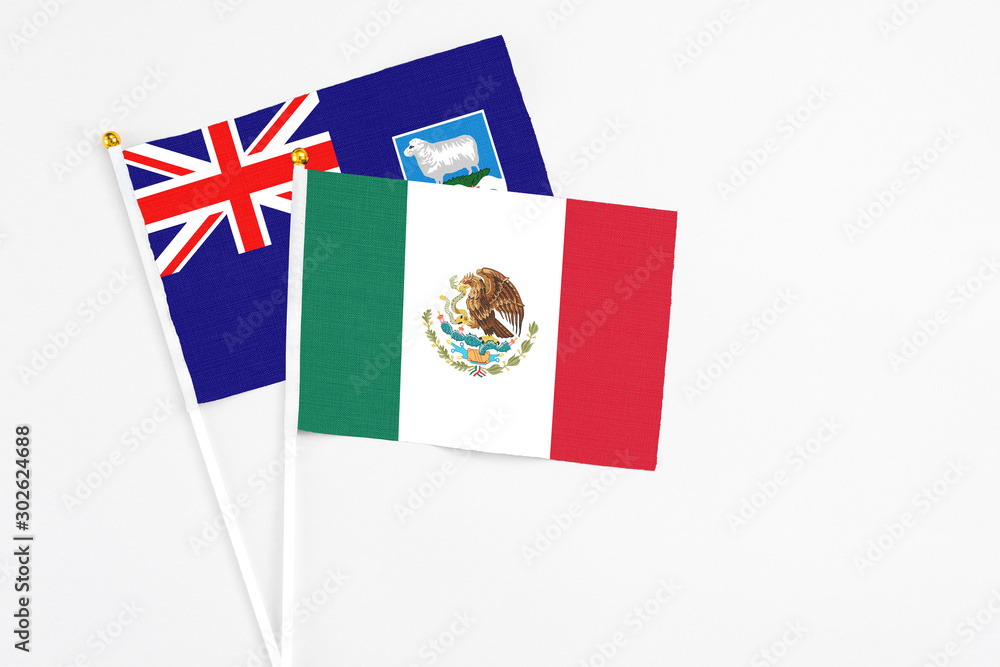 Mexico and Falkland Islands stick flags on white background. High quality fabric, miniature national flag. Peaceful global concept.White floor for copy space.