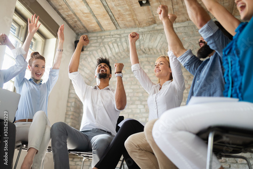 Happy success business team celebrating victory in office