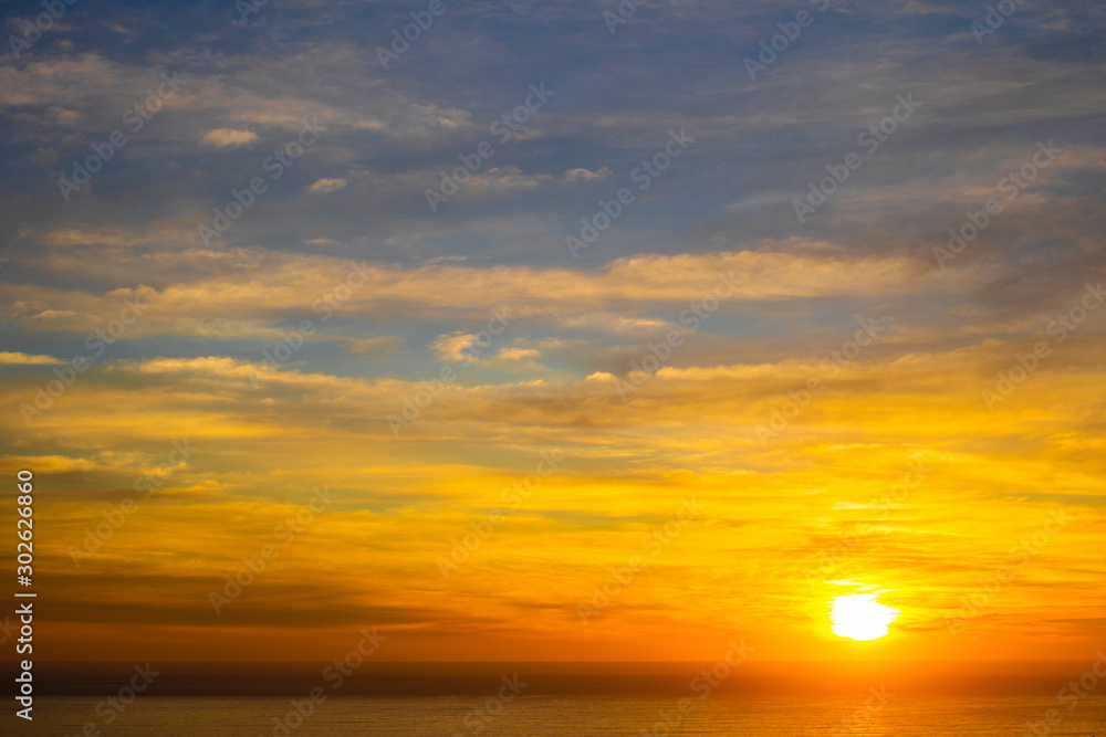 Beautiful and peaceful golden blue sunset or sunrise over the ocean.