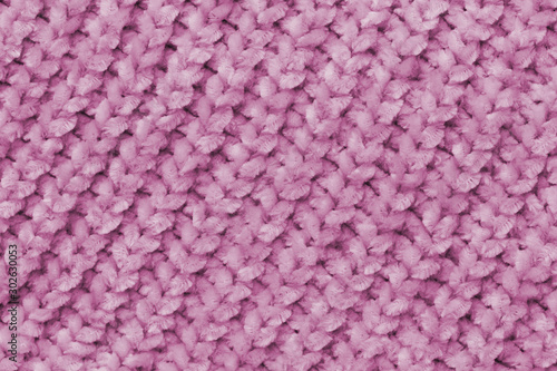 Fluffy soft pink fabric with waves and folds. Soft pastel textile texture. Folds on a soft cloth.