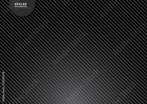 Black carbon kevlar fiber background and texture with lighting.