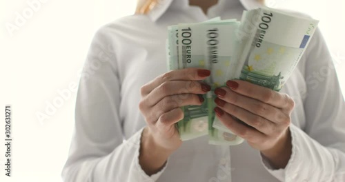 Business Woman Counting Money. Close up of female hands counting euro banknotes.