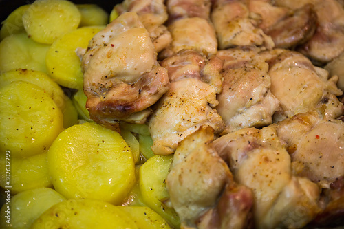 Home cooking. Chicken fillet is baked with potatoes on a baking sheet. Moscow, Russia.