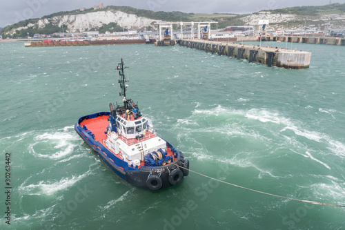 Port of Dover. A tugboat helps the ferry maneuver