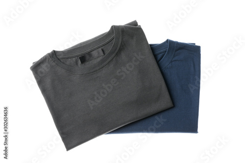 Folded t-shirts isolated on white background, space for text