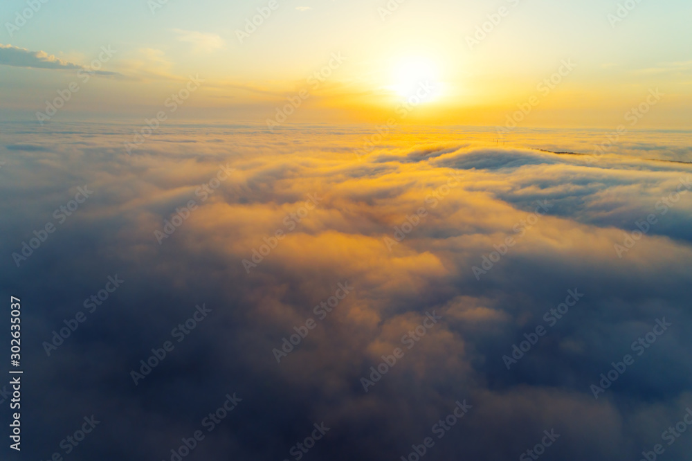 Beautiful sunset, above clouds. Aerial shot by a drone.