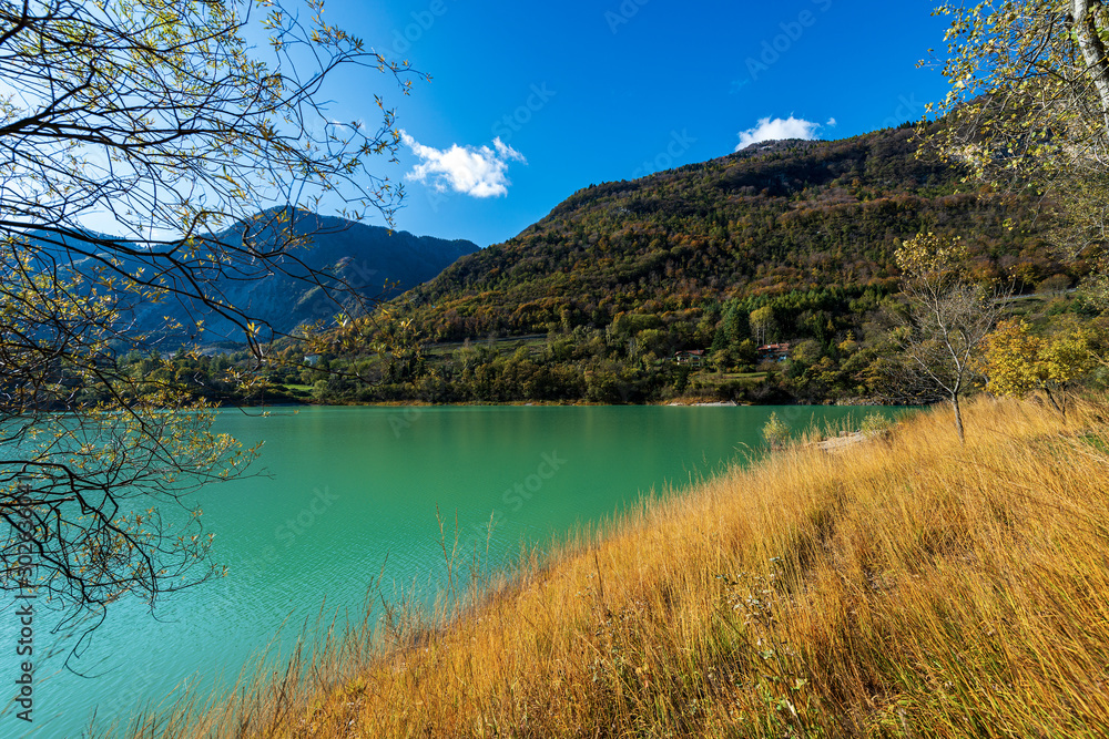 Small beautiful lake in Italian Alps in autumn. Lago di Tenno, Trento province, Trentino-Alto Adige, Italy, Europe