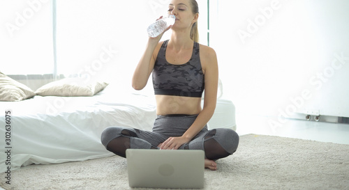 Fitness training online, senior woman at home with laptop