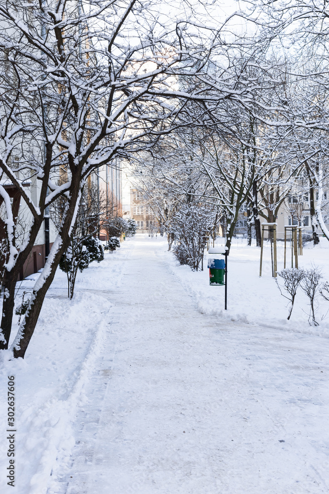Sidewalk in the snow in a typical Polish block of flats in winter