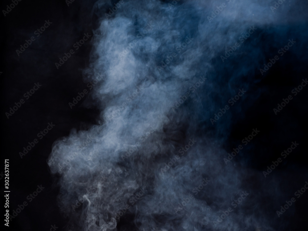 Light puffs of smoke rise. Studio photography Light puffs of smoke rise. Studio photography
