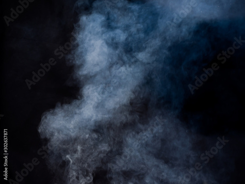 Light puffs of smoke rise. Studio photography