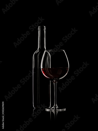 bottle and wine glass with red wine