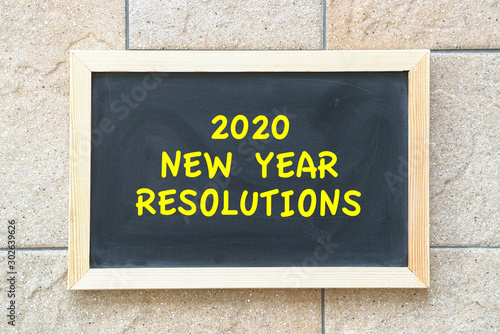 2020 new year goal, plan, action text on black board.