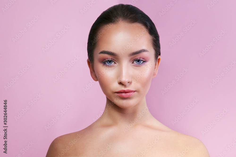 Portrait of young beautiful woman with perfectly clean face skin wearing professional make up. Female with long black hair. Close up, copy space background. Portrait of young beautiful woman with perfectly clean face skin wearing professional make up. Female with long black hair. Close up, copy space background.