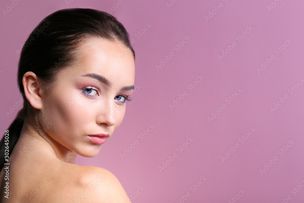 Fototapeta premium Portrait of young beautiful woman with perfectly clean face skin wearing professional make up. Female with long black hair. Close up, copy space background.