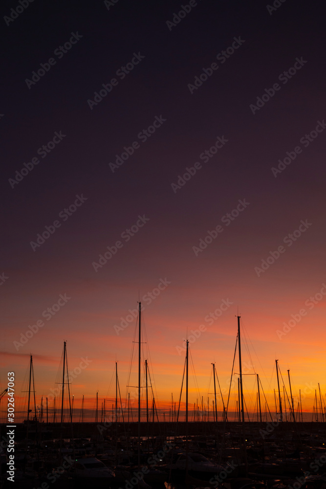 Lavagna Italy Ligurie. Sunset with masts of ships in harbor.