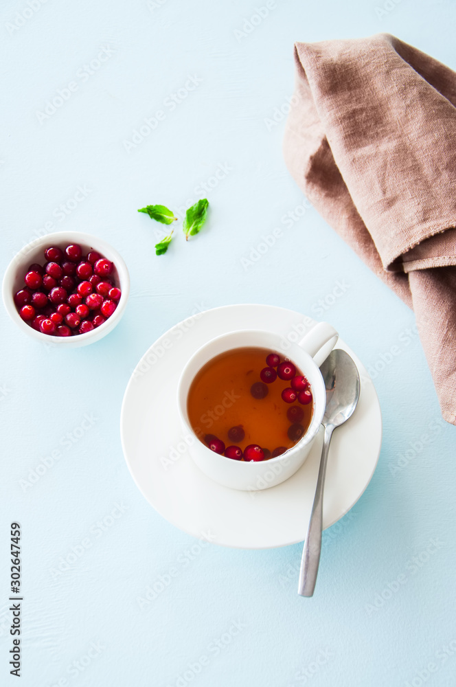 Tea with cranberry on a light blue background. Tea with cranberry on a light blue background.