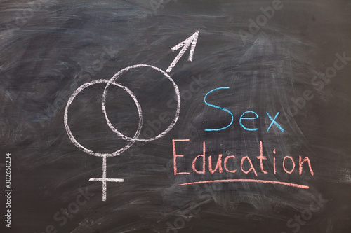 Sex Education. Male and female sex symbol on black chalkboard