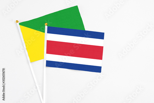 Free Download Costa Rica and French Guiana stick flags on white background. High quality fabric, miniature national flag. Peaceful global concept.White floor for copy space. - GFXLoad