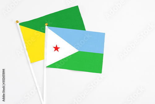 Free Download Djibouti and French Guiana stick flags on white background. High quality fabric, miniature national flag. Peaceful global concept.White floor for copy space. - GFXLoad