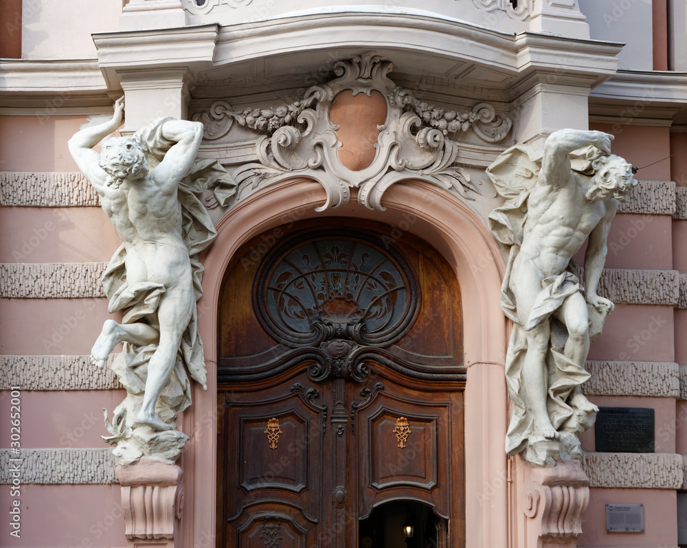 LVIV, UKRAINE - NOVEMBER 9, 2019: Atlantis sculptures at the door of the building.