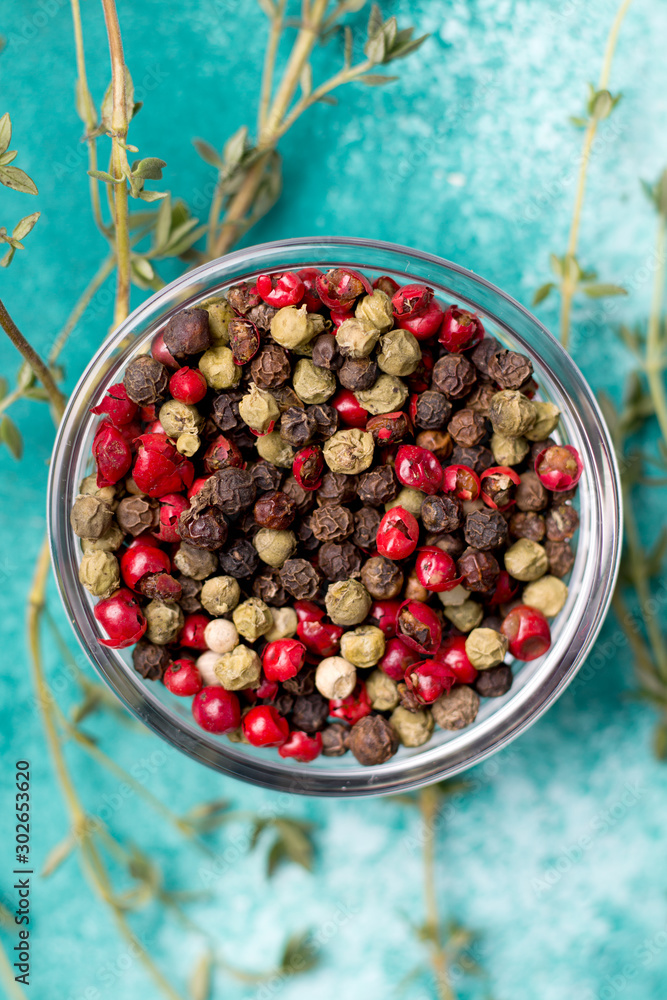 pepper peas on a blue background with herbs. view from above pepper peas on a blue background with herbs. view from above