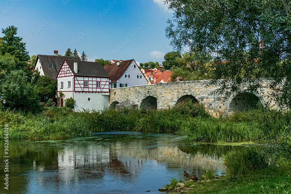 View of the small town of the romantic route from the Wörnitz riverbank. Photography taken in Harburg, Bavaria, Germany.