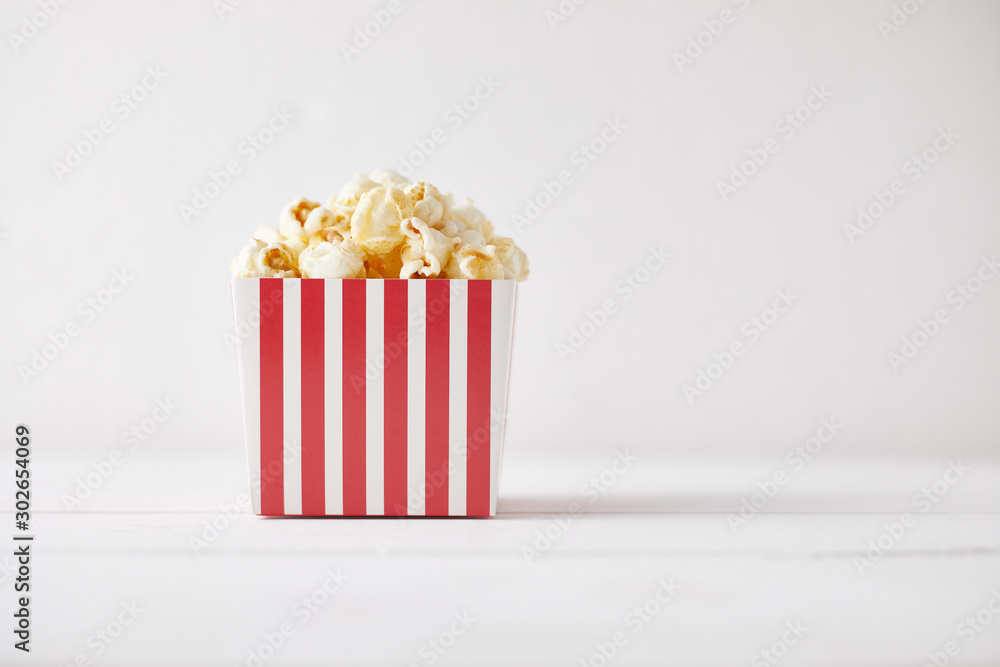 Full of tasty caramel popcorn in classic striped box..