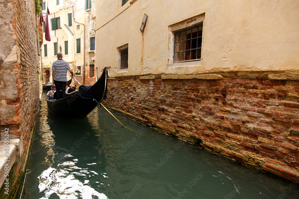 Gondolier on gondola, Venice, Italy