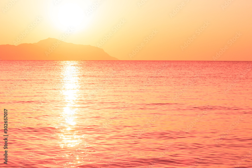 Sunrise over the sea in trendy color living coral. Photo toned in trendy color of the year 2019.