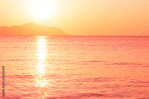 Sunrise over the sea in trendy color living coral. Photo toned in trendy color of the year 2019.