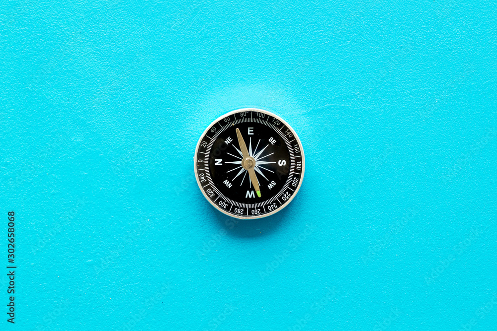 Compass - small and stylish - on blue background top view copy space - obrazy, fototapety, plakaty 