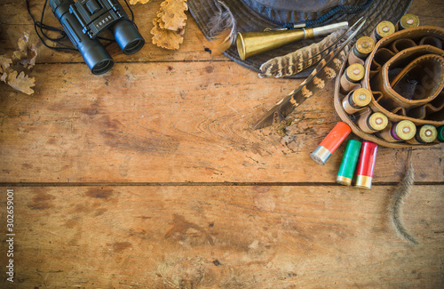 Hunting equipment on the old wooden background with copy space