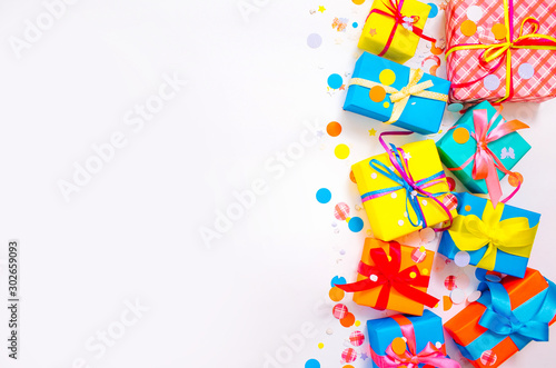 Gift wrapped in paper. Small gifts are packed in colored paper. Colored ribbons. Gift wrapping. White background. View from above. Pastel shades
