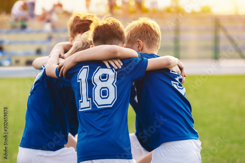 Kids in sports team. Happy boys in football team. Children sports education p...
