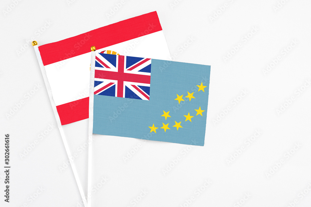 Tuvalu and French Polynesia stick flags on white background. High quality fabric, miniature national flag. Peaceful global concept.White floor for copy space. Tuvalu and French Polynesia stick flags on white background. High quality fabric, miniature national flag. Peaceful global concept.White floor for copy space.