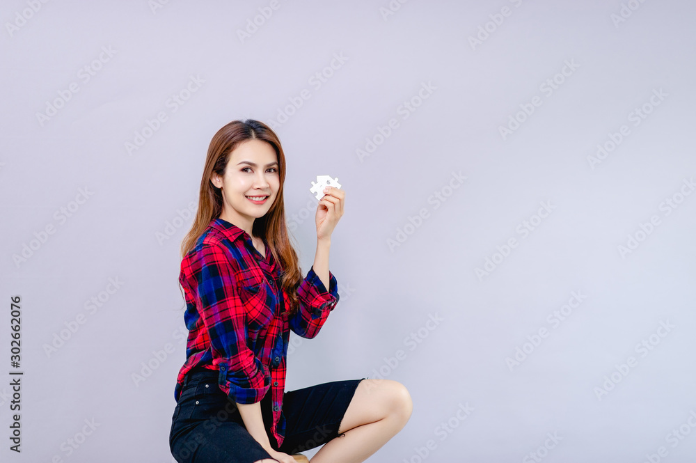 A woman and a jigsaw in a white hand Concepts of cooperation and coordination A woman and a jigsaw in a white hand Concepts of cooperation and coordination