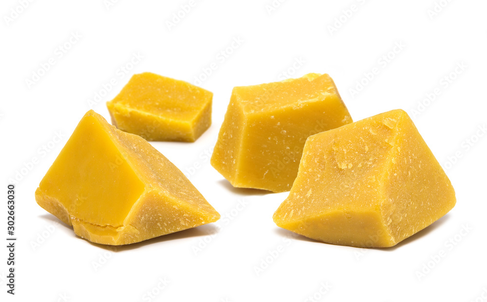 Block pieces of yellow natural bees wax isolated on white background.