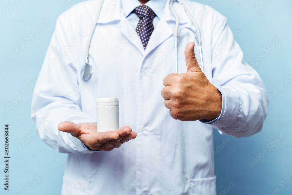 doctor holding bottle of pills on white background. The concept of medicine, pharmacology, healthcare doctor holding bottle of pills on white background. The concept of medicine, pharmacology, healthcare