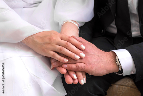 female and male hands together, couple, groom, bride photo