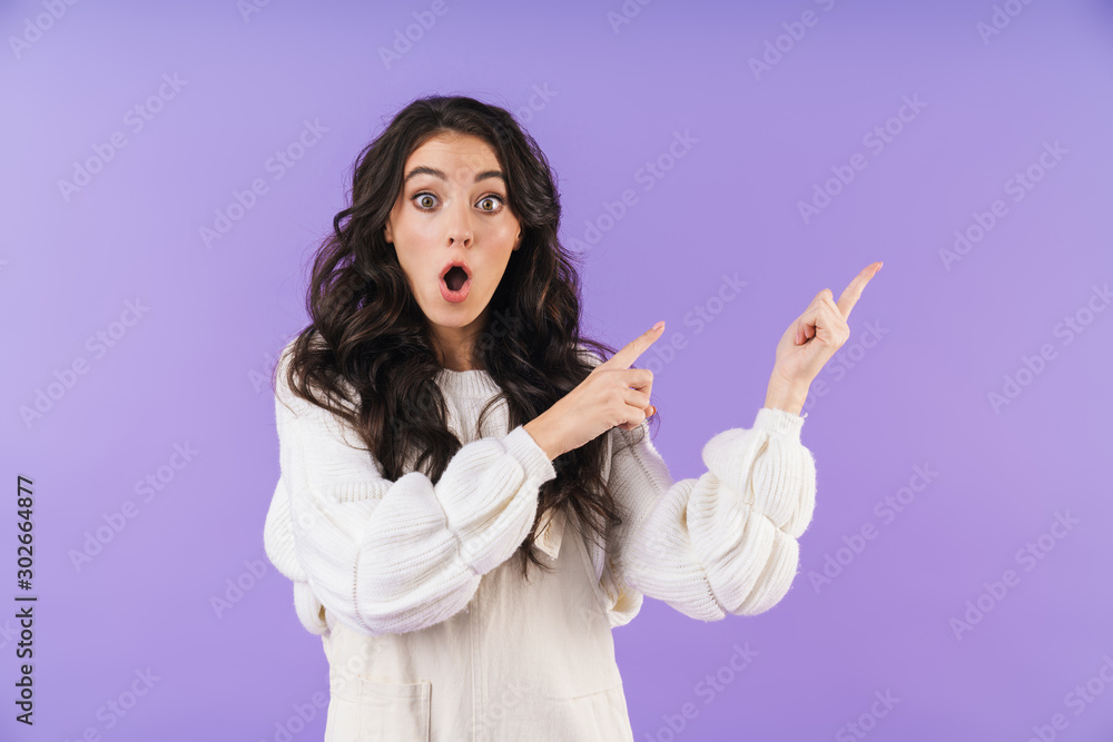 Emotional young brunette woman pointing aside. Emotional young brunette woman pointing aside.