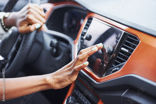 Close up view of african american woman's hands inside of new modern car © standret