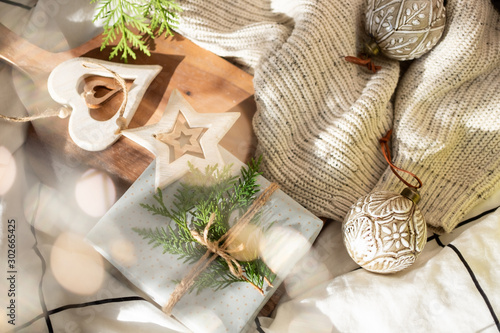 Festive Christmas and New Year decorations and present in scandinavian style with rustic handmade details in natural and white tones