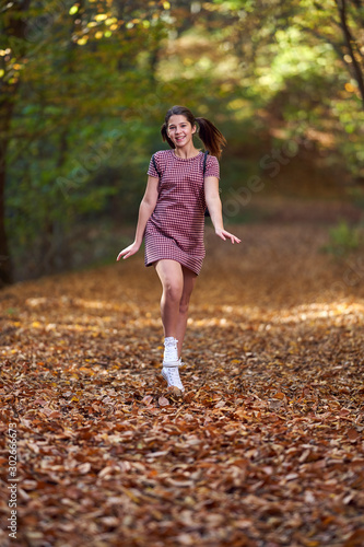 Schoolgirl walking in the forest