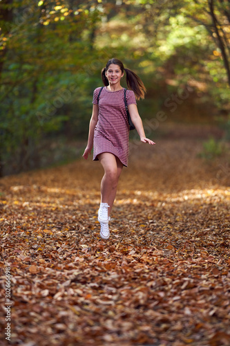 Schoolgirl walking in the forest