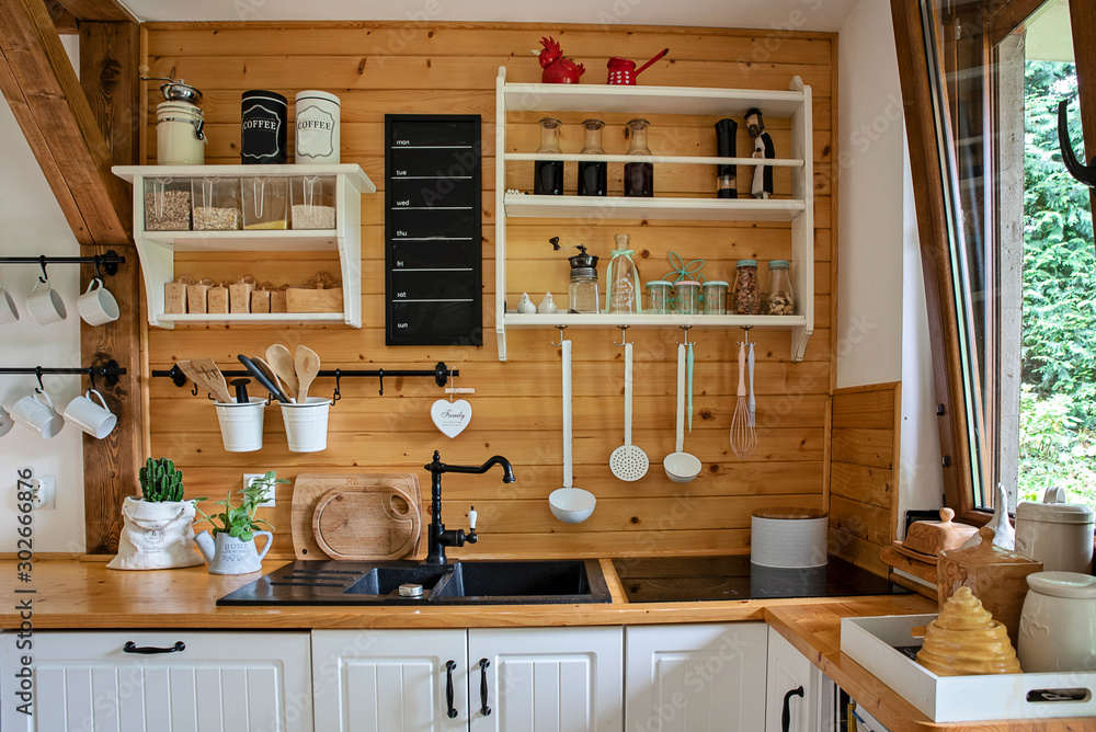 Vintage rustic interior of kitchen with white furniture, wooden wall ...