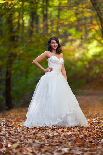 Bride in white dress in the forest