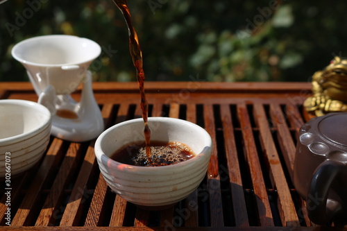 Chinese tea ceremony using tea utensils in nature.