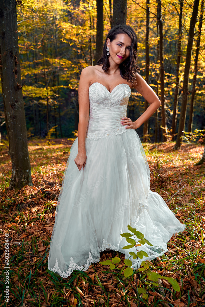 Bride in white dress in the forest