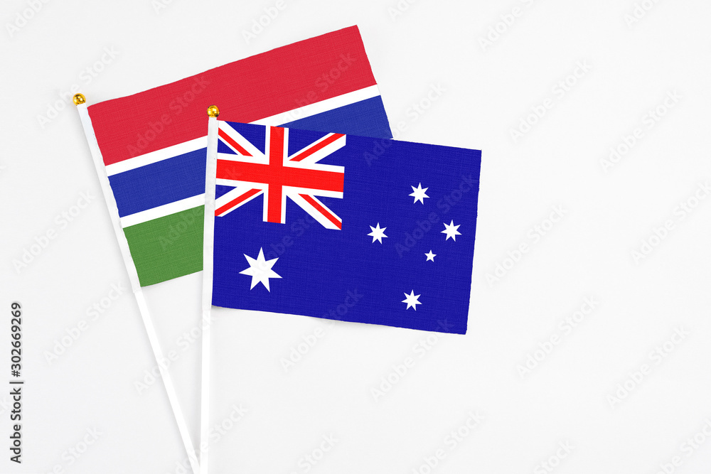 Fototapeta premium Australia and Georgia stick flags on white background. High quality fabric, miniature national flag. Peaceful global concept.White floor for copy space.
